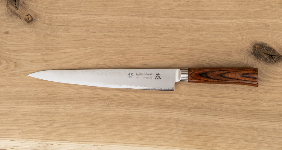 Tamahagane Tsubame Sujihiki (or slicer) knife is primarily intended for long pulls and precise cuts of meat and fish. The 240mm (9.5") version is designed for medium-sized fish and pieces of meat. A matte blade finish, featured with the core VG-5 steel hardened to 61 HRC.