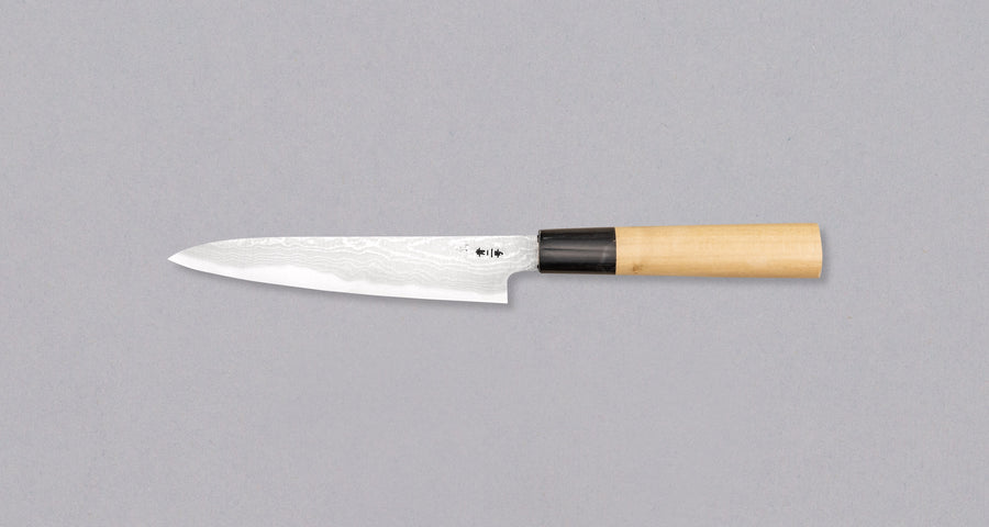 The minimalistic, lightweight petty was forged by the famous Shigeki Tanaka. It comes in a traditional Japanese paulownia wood box and makes a truly special gift. The superior Aogami #2 steel ensures long-lasting sharpness and easy sharpening. It's fitted with a traditional magnolia handle in D-shape.