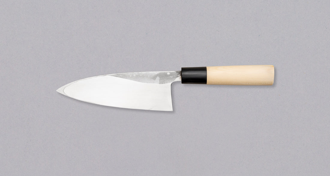 Japanese kitchen knife deba, made from Shirogami steel by the Tojiro smithy. Magnolia handle with a buffalo horn ferrule. Buy now at SharpEdgeShop.com
