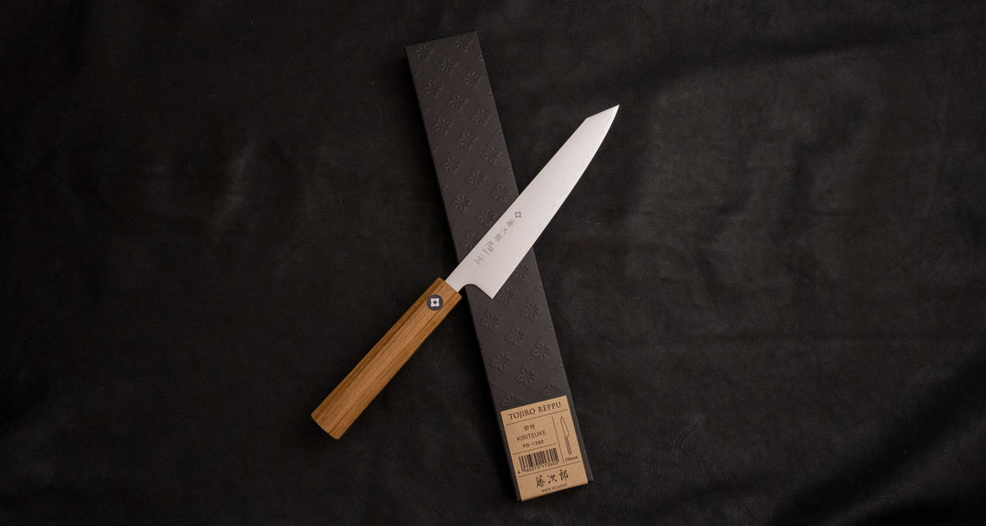 Tojiro Petty Reppu SG2 150 mm knife with SG2 powder steel core and a durable teak wood handle, ideal for precise kitchen tasks.