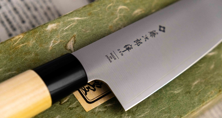 Tojiro Santoku Zen in 165mm is a great choice if you're looking for a handy, multi-purpose, low-maintenance knife that is very affordable. Stainless steel, traditional Japanese magnolia wood handle, minimalist blade finish - enjoy the classic Japanese aesthetic.