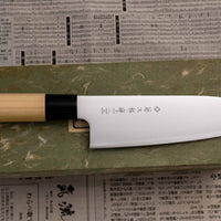 Tojiro Santoku Zen in 165mm is a great choice if you're looking for a handy, multi-purpose, low-maintenance knife that is very affordable. Stainless steel, traditional Japanese magnolia wood handle, minimalist blade finish - enjoy the classic Japanese aesthetic.