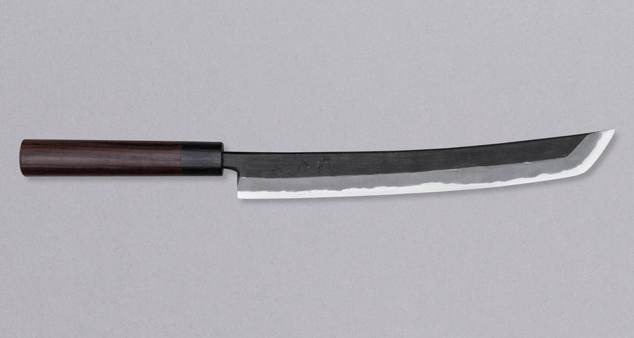 The Tsunehisa Sakimaru Sujihiki Aogami #2 300mm is a traditional Japanese knife used for preparing meat and fish, especially for sashimi and nigiri sushi. The name sakimaru refers to the tanto tip, which is one of the main features of a katana.