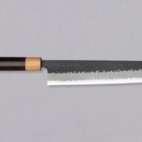 Tsunehisa Kiritsuke AS Kuro-uchi 240mm (9.4") is a multi-purpose knife with a black Kuro-uchi protective patina and tsuchime hammer indentations. Its length makes it great for cutting larger pieces of meat and fish. The Kuro-uchi (black) patina on the upper part of the knife gives it a unique and rustic appearance.