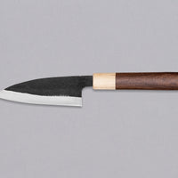 This Ajikiri SUJ-2 blade made by Yoshida Hamono is a Japanese knife for small fish. It's fitted with an oval rosewood handle which is topped with a cedar ferrule. The blade is forged from SUJ-2 steel with a hardness is 63-64 HRC, which holds its edge for a long time and is very easy to resharpen.