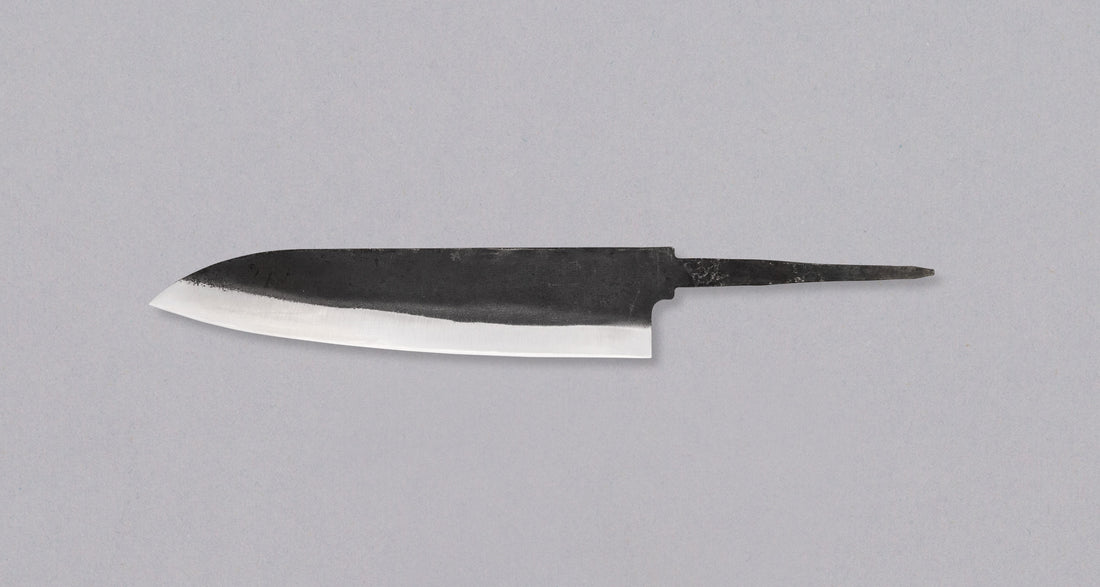 Yoshida Gyuto SUJ-2 Kuro-uchi 210mm (8.3") is a multi-purpose blade made in the Japanese smithy Yoshida Hamono. It's made from high-carbon SUJ-2 steel, so it is easy to sharpen and stays sharp for a long time. With its minimalist kuro-uchi look it will combine well with both classic and more extravagant handles.