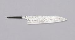 Yoishida Gyuto ZDP-189 damascus in 240mm length. The blade is made from the best powder steel, ZDP-189, so it's rust-resistant, low-maintenance, and keeps a super sharp edge for a very long time. At 240mm (9.4"), this gyuto is the perfect length for all cutting work in the kitchen, be it making steaks or chopping veg, as long as it is accompanied by a trusty petty for all those smaller, in-hand tasks.