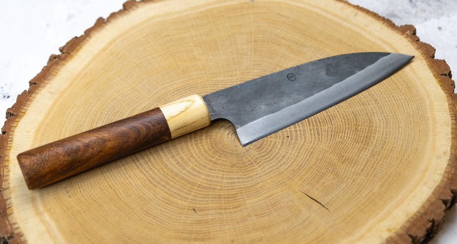 This Santoku Funayuki SUJ-2 blade is fitted with an oval rosewood handle with a cedar ferrule. Great for cutting smaller pieces of meat and filleting fish.  The blade is forged from SUJ-2 steel, which offers incredible capacities, hardness is 63-64 HRC, and at the same time, the knife is very easy to resharpen. 