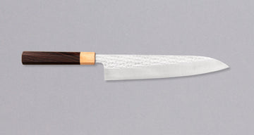 Kurosaki Gyuto from the Senko line is another uniquely looking blade from the hands of a talented young master blacksmith Yu Kurosaki. The unique hammer imprints on the top part of the blade resemble a dazzling diamond pattern − hence the name SENKO. The blade has a high polish finish.