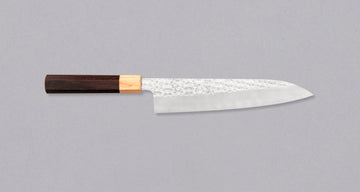 Kurosaki Gyuto from the Senko line is another uniquely looking blade from the hands of a talented young master blacksmith Yu Kurosaki. The unique hammer imprints on the top part of the blade resemble a dazzling diamond pattern − hence the name SENKO. The blade has a high polish finish.