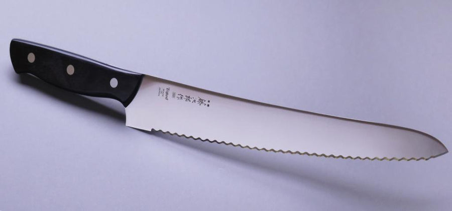 Micarta Pankiri (Bread Knife) 270mm (10.6")_2  A hand-forged Tojiro Micarta 270mm (10.6") bread knife with a compact black woods handle and a long blade (270 mm) is an indispensable tool for either professional chefs or passionate home cooks (sourdough enthusiasts, raise your hands!). The blade is made from Molybdenum Vanadium steel with 57–59 HRC.