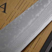 Etsu Village Damascus Santoku Black 170mm (6.7")_2  Damascus Santoku Black features a Western-style (Yo) handle from black micarta. This knife will be a great addition to your kitchen, suitable for cutting veggies, meat and fish. Blacksmith Masutani is known as an incredibly good knife sharpener, and his knives are no different, featuring a very thin spine (around 1.8mm).