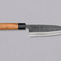 Muneishi Santoku Aogami #2 Kuro-uchi 210mm is a multi-purpose Japanese kitchen knife, suitable for preparing meat, fish, and vegetables. High-carbon Aogami #2 steel is easy to sharpen to a very fine sharpness. A  beautiful cherry wood oval handle has a pakka ferrule – providing a nice contrast to the dark blade.