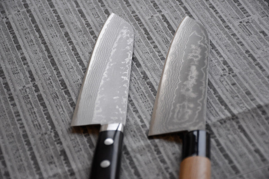 Etsu Village Damascus Santoku Black 170mm (6.7")_5  Damascus Santoku Black features a Western-style (Yo) handle from black micarta. This knife will be a great addition to your kitchen, suitable for cutting veggies, meat and fish. Blacksmith Masutani is known as an incredibly good knife sharpener, and his knives are no different, featuring a very thin spine (around 1.8mm).